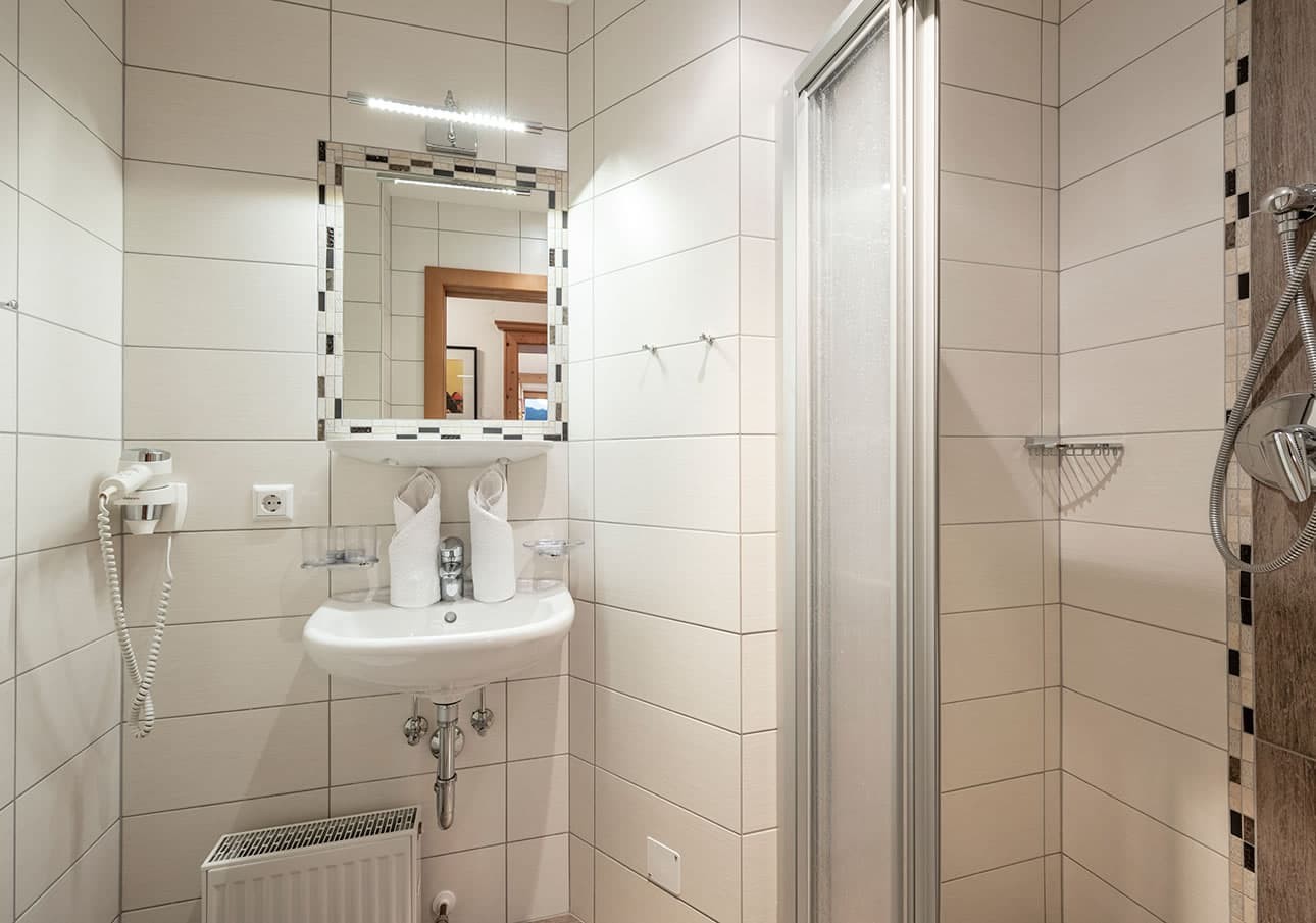 Modern bathroom with a sink, mirror, and shower