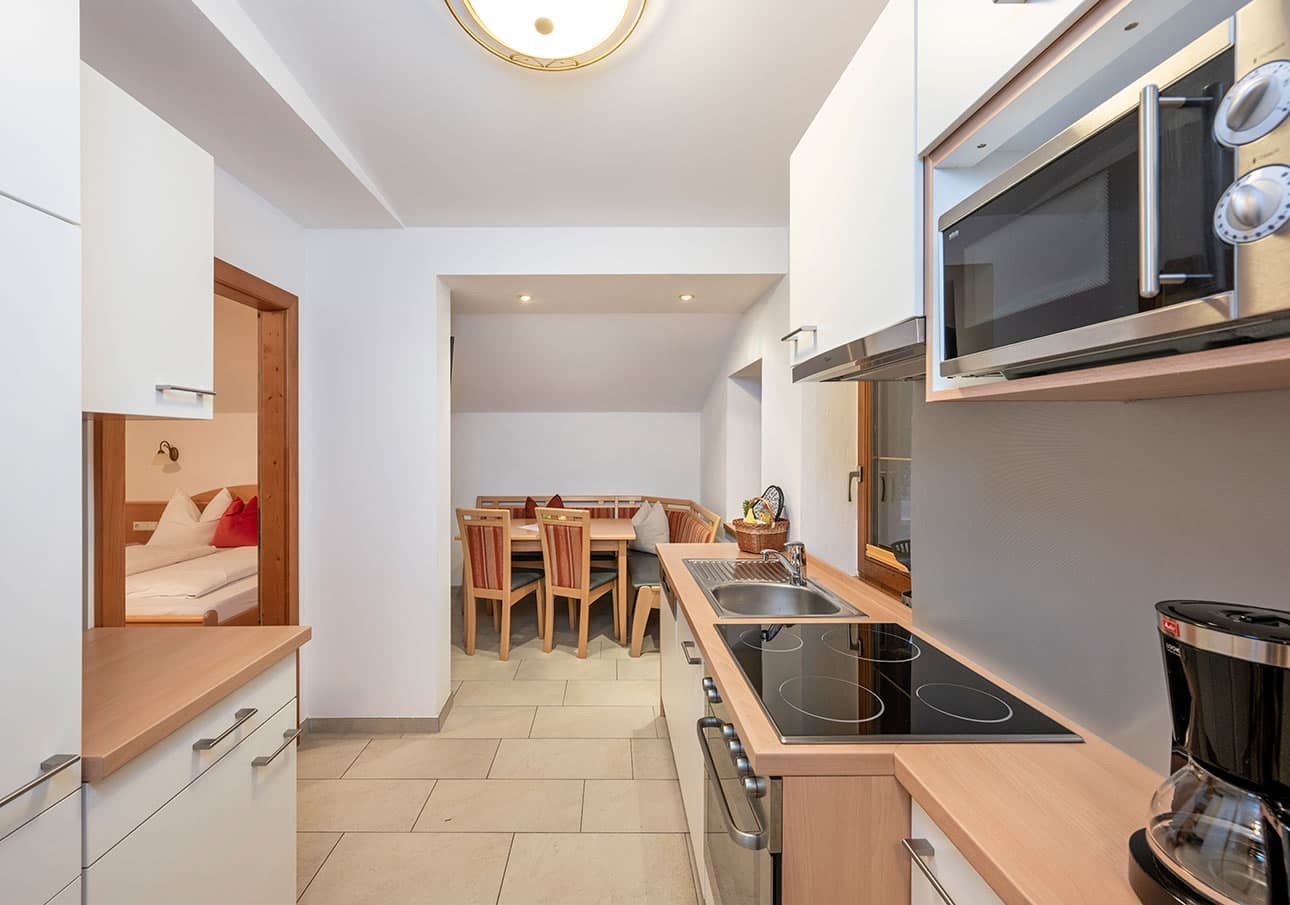 Modern kitchen and dining area with wood accents and stainless steel appliances